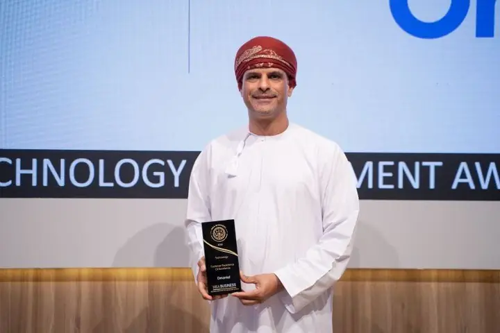 Omantel with the Customer Experience CX Excellence award on the awards stage