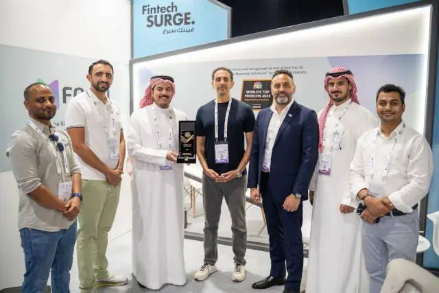 Winning team with their trophy on their stand at Fintech Surge