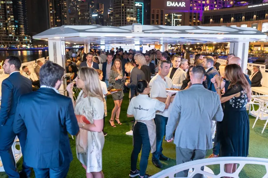 Guests mingling on the yacht deck in Dubai Marina