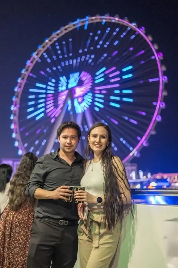 Guests on board in front of the illuminated Ain Dubai wheel